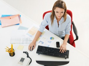 business woman in office using desktop computer.